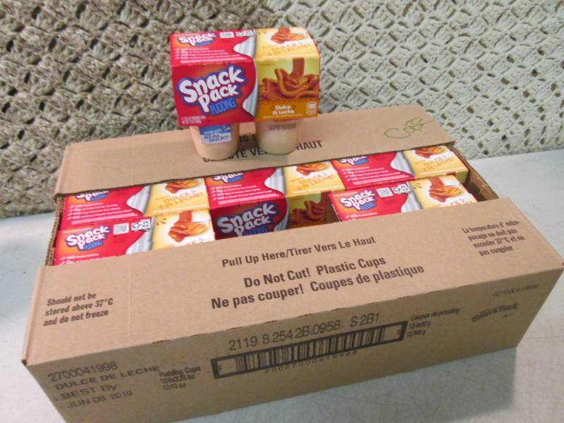 lot 37 image: Case of 12 4-Pack Cups of Dulce de ...