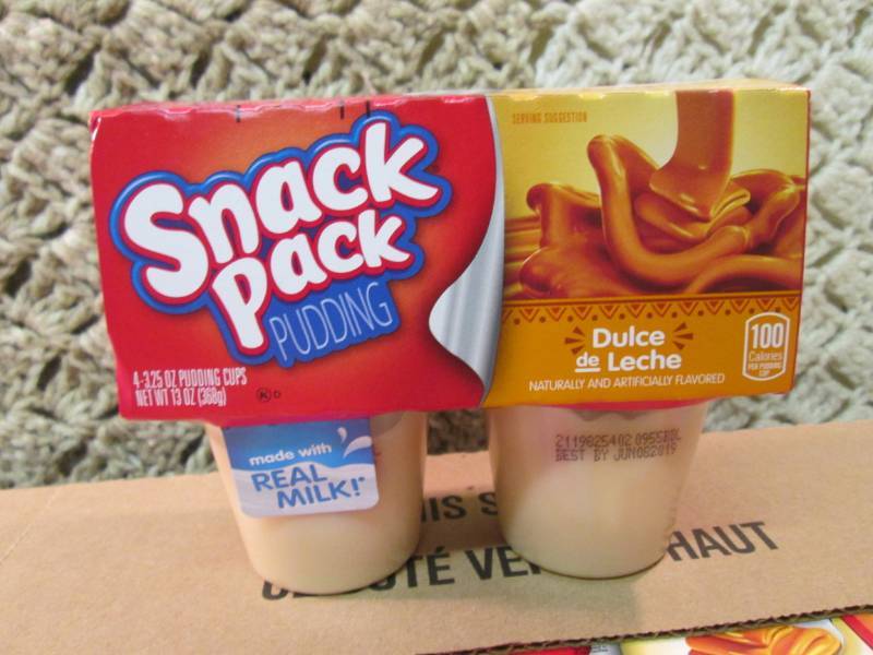 lot 38 image: Case of 12 4-Pack Cups of Dulce de ...
