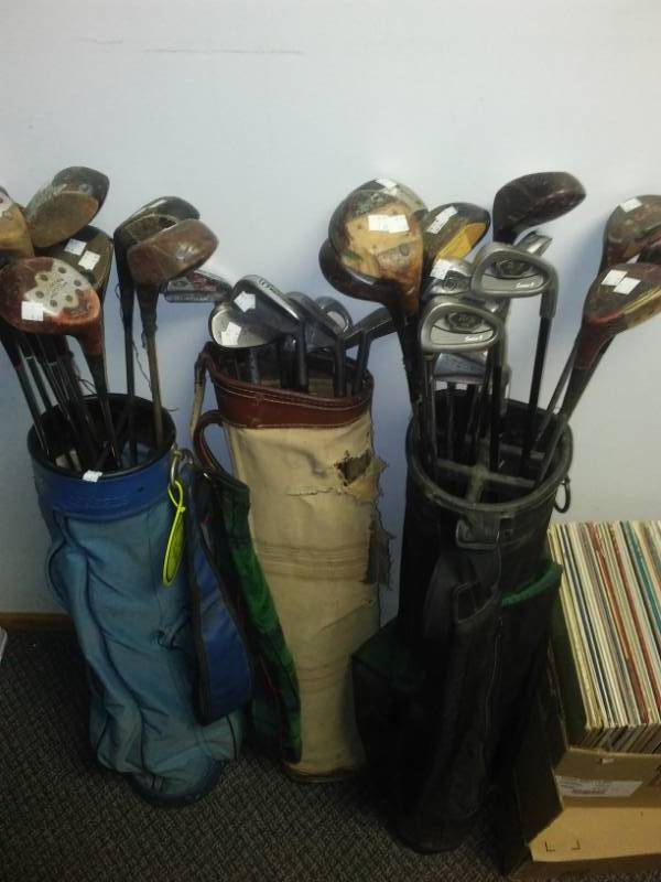 lot 61 image: Three golf bags and approximately 30 golf clubs.