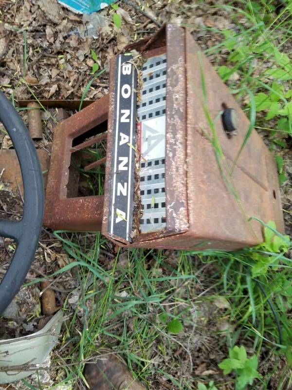 lot 10 image: Parts and hood from an old Bonanza Lawn Mower