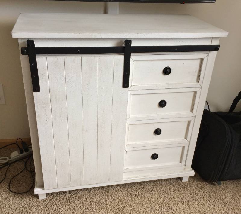 lot 7 image: CHARMING & CHIC WHITE WASHED WOOD & IRON CABINET WITH 4 DRAWERS AND SLIDING FRONT DOOR REVEALS 2 SHELVES FOR PLENTY OF STORAGE - PURCHASED LESS THAN A YEAR AGO AND IN LIKE NEW CONDITION