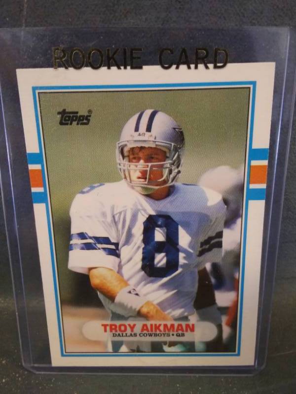 lot 55 image: Troy Aikman Edge Authentic Football Card with Piece of Game Ball & Topps Rookie Card