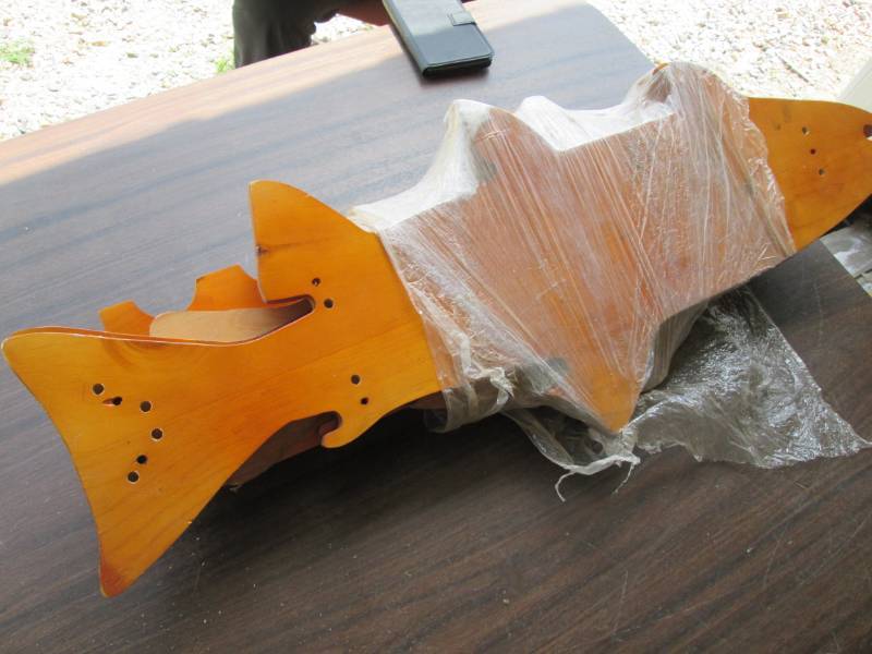 lot 108 image: Fish shaped wood fishing rod holder...