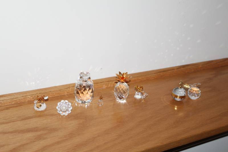 lot 155 image: Lot of (8) Swarovski Fruit,Phone,Bells,Pacifier Crystal Table Figurines and Dcor