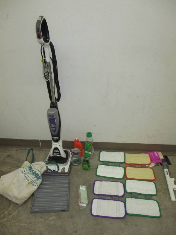 lot 110 image: Shark Scrubbing Duo Floor Cleaner with lots of extra pads and some cleaners