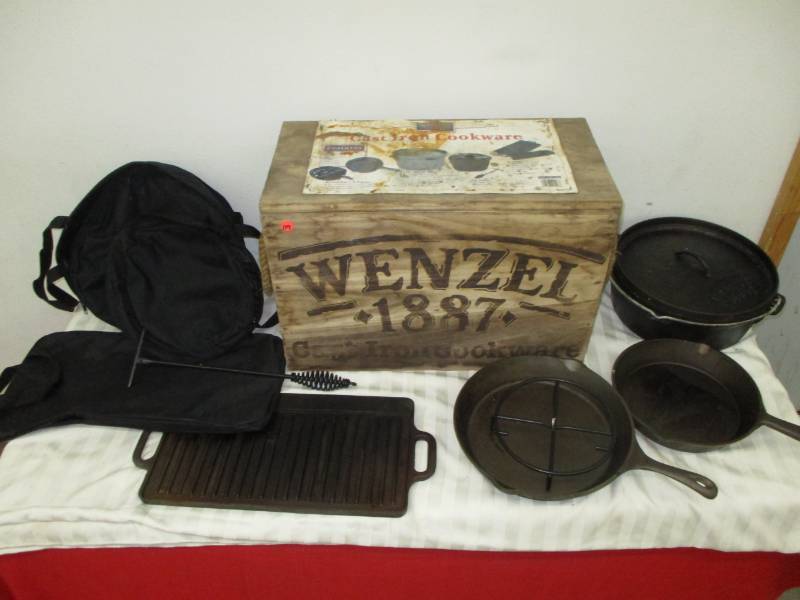 lot 119 image: WENZEL Castr Iron Set in Box, 2 PC Skillet, Lid Lifter, 6 QT Dutch Oven, Griddle covers and Wooden Box for it all Never Used still needs to be seasoned