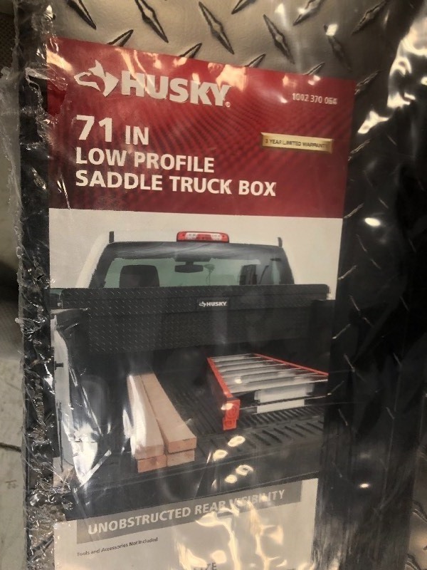lot 101 image: Husky 71.3 in. x 20.5 in. x 15.6 in. Matte Black Aluminum Full Size Low Profile Truck Tool Box not used whit damage on the front side please review the photos