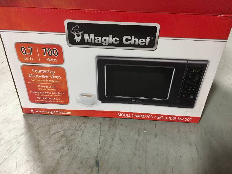 lot 48 image: Magic Chef 0.7 cu. ft. Countertop Microwave in Black with Gray Cavity in good condition