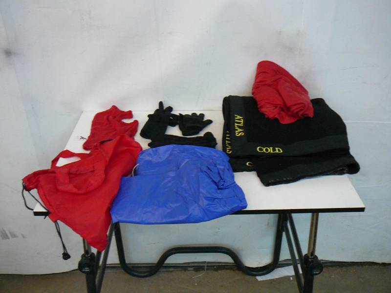 lot 232 image: Rubbermaid Tote With Womens GlovesThrow BlanketsRain Poncho