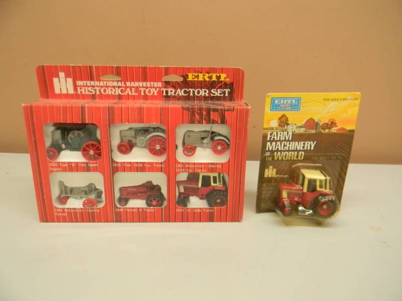 lot 108 image: ERTL INTERNATIONAL HARVESTER HISTORICAL TOY TRACTOR SET 164 SCALE DIE CAST WITH ERTL INTERNATIONAL HARVESTER TRACTOR - STILL IN PACKAGE - SEE PICTURES