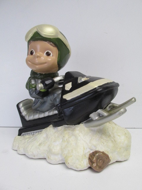lot 36 image: Vintage Boy on Snowmobile Ceramic Statue