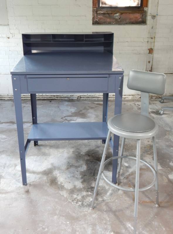 lot 4 image: Metal Slanted Standard Shop Desk and National Public Seating Company Padded Stool with Backrest