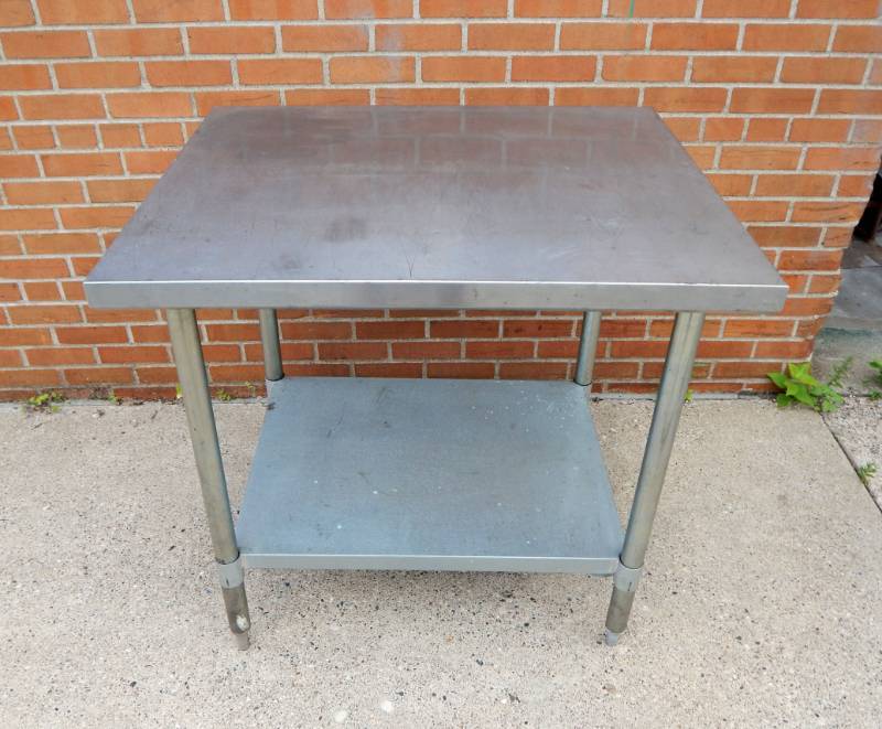 lot 9 image: Duke Manufacturing Stainless Steel Worktable with Adjustable Shelf