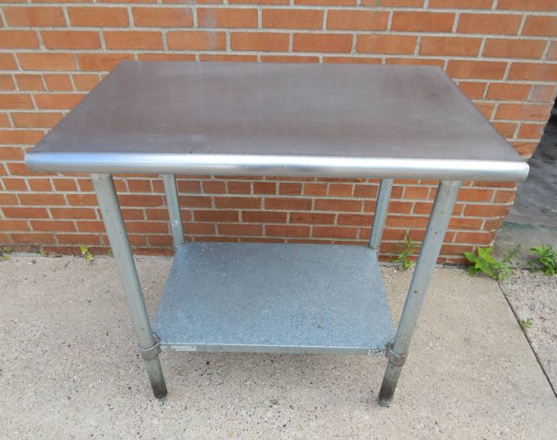 lot 11 image: Duke Manufacturing Stainless Steel Worktable with Adjustable Shelf