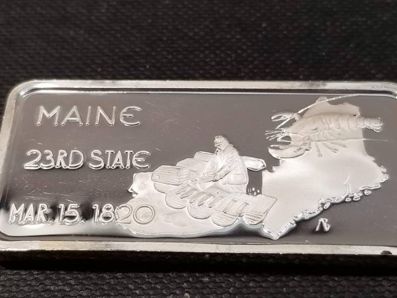 lot 33 image: 1 TROY OZ. .999 FINE SILVER ART BAR MAINE