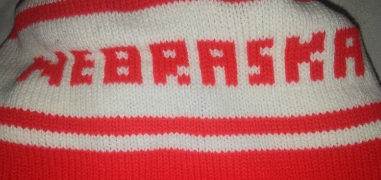 lot 86 image: Scarf and cap. Nebraska Cornhuskers