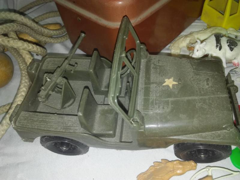 lot 189 image: Toys - Jeep and tank, troll, plastic Play Pieces, Lincoln Log can, wood balls.