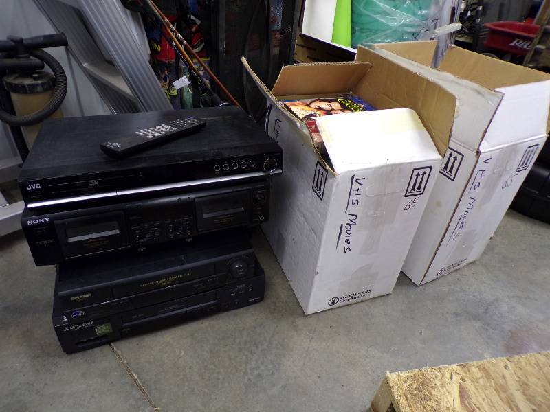 lot 144 image: 2 VCRs - sony cassette deck- JBC dvd player- 2 boxes VHS movies