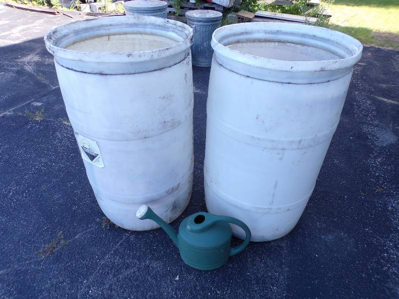 lot 290 image: Pair of 55 Gallon Plastic Barrels with Watering Can