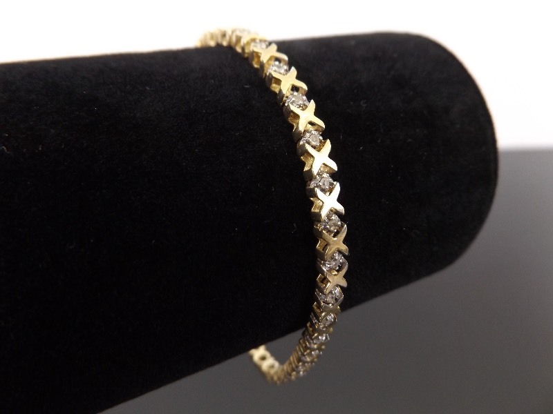 lot 58 image: 10k Yellow Gold Diamond Accented Hugs and Kisses Tennis Bracelet
