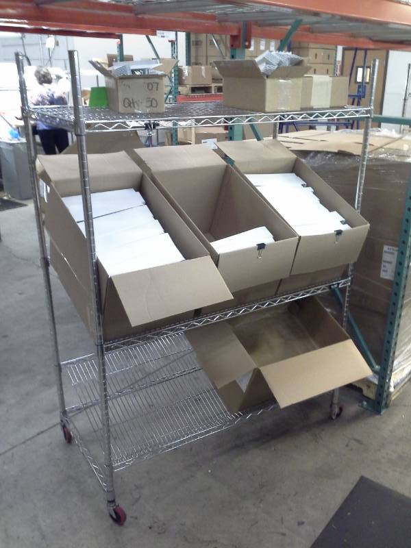 lot 51 image: Uline NSF Rolling Metal Wire Rack Shelving Unit with 2-Sloped Shelves, 2-Flat Shelves