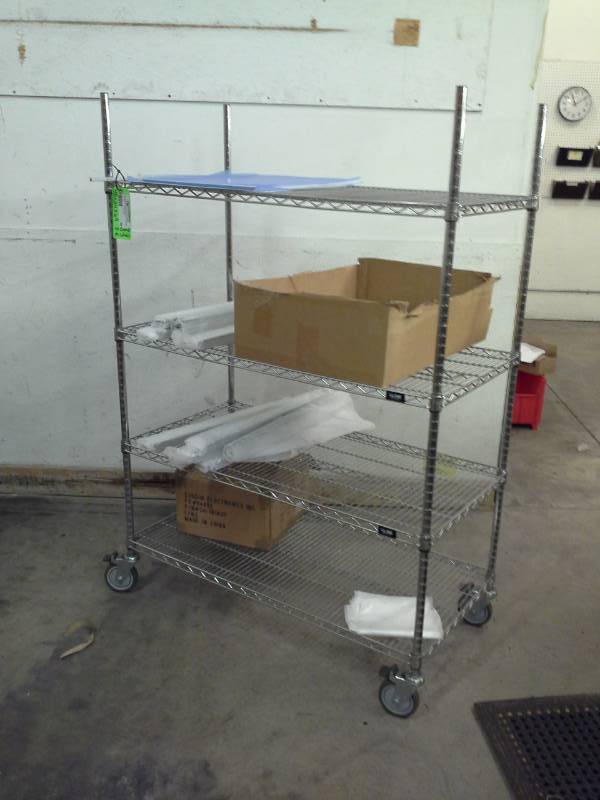 lot 86 image: Uline NSF Rolling Metal Wire Rack Shelving Unit with 4-Shelves