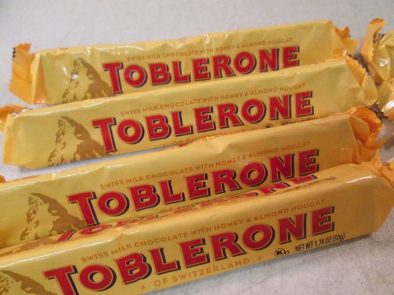 lot 107 image: 12 Toblerone Candy Bars Best by Aug...