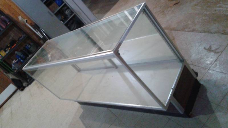 lot 69 image: Glass Store Display Cabinet, Used, Some Wear, No Shelves Or Brackets, Has Sliding Back Doors, Back Sliding Mirror Has tiny crack In Corner, Hard To Notice 70 x 20 x 39