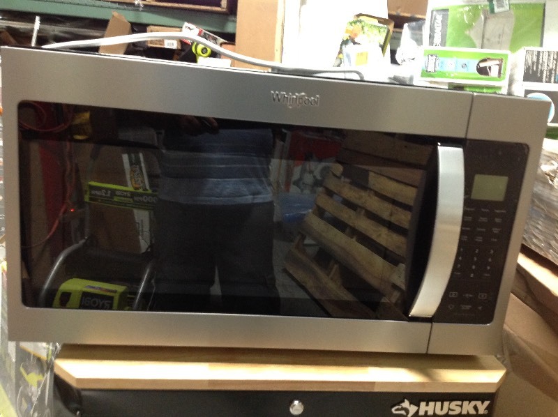 lot 117 image: Whirlpool 1.9 cu. ft. Over the Range Microwave in Fingerprint Resistant Stainless Steel with Sensor Cooking not used whit dent on the top back please review the photos