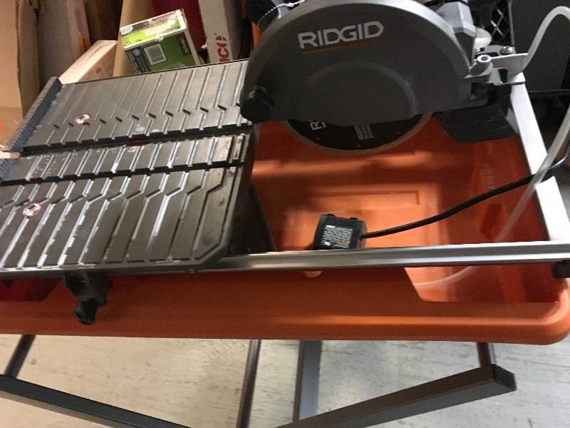 lot 100 image: RIDGID 9 Amp Corded 7 in. Tile Saw with Stand USED in good condition