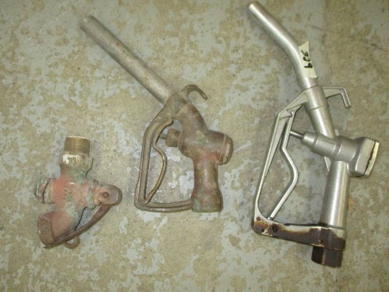 lot 23 image: Brass Faucets , Brass Gas Pump Nozzle, and another Gas Pump Nozzel