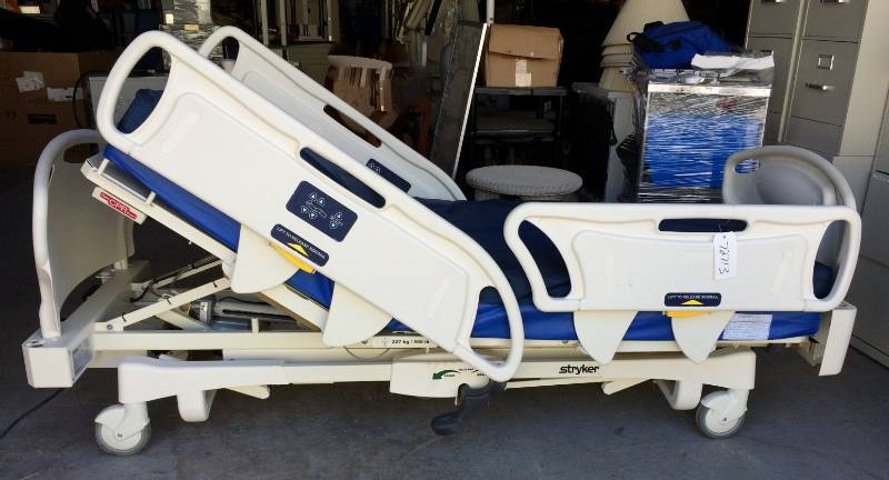 lot 13 image: GIVE YOUR LOVED ONE THE BEST Stryker MEDSURG Bed Power Motorized Adjustable 500lb Capacity Hospital In-Home Health Patient Care Bed - Plugs Into Regular Light Socket Free Used High Quality Comfortex Mattress