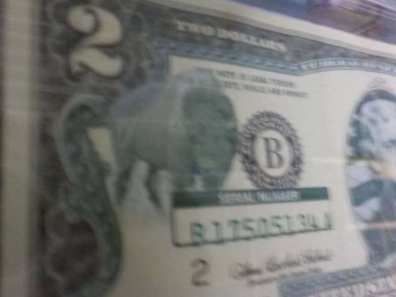 lot 110 image: 2 Dollar Bill in a plastic Sleeve ...