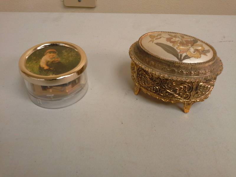 lot 154 image: Lot of (2) Bohme Music Co. Girl with Flowers Music Box, Hummingbird Music Box