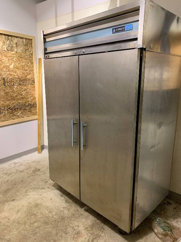 lot 5 image: DelField two door commercial Freezer, NSF caster mounted, 115 volts, 9.0 amps, 54x30x83.5Hin Working Condition
