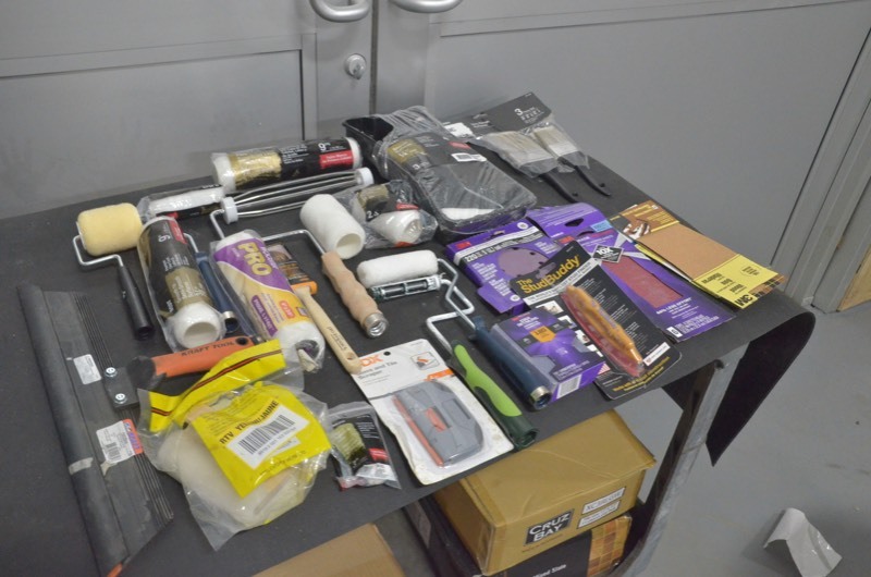 lot 57 image: Painters lot- Paint rollers, roller handles, sand papers, stud finder, paint brushes, sanding sponge, 18 in squeegee, glass and tile scraper