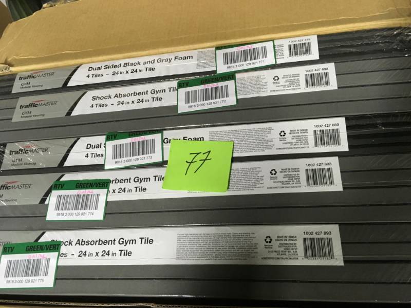 lot 77 image: TrafficMASTER Black 25.4 in. x 25.4 in x 0.68 in. Shock Absorbing Gym Floor (4-Pack) in good condition