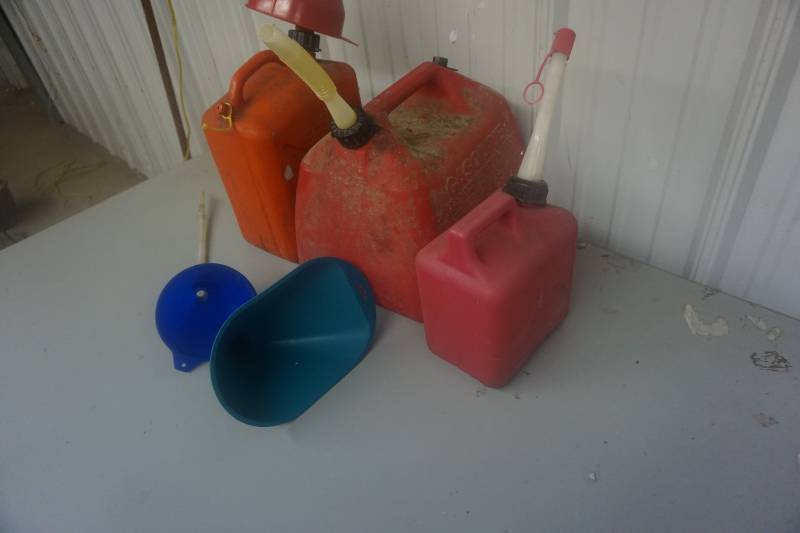 lot 115 image: Lot of 3 Gas Cans & 3 Funnels In Assorted Sizes
