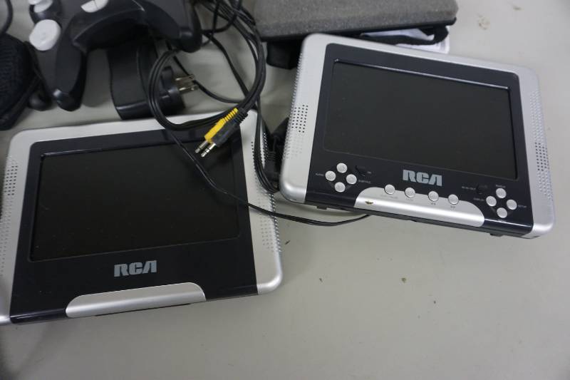 lot 109 image: RCA Brand 3 Screen Portable DVD PlayerGame Controller With Nextar Brand GPS