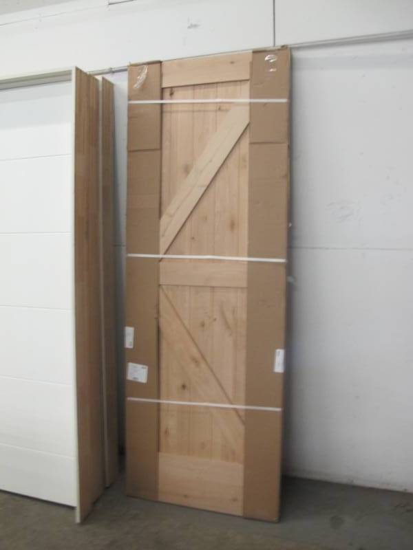 lot 15 image: Steves & Sons 30 in. x 80 in. 2-Panel Solid Core Unfinished Knotty Alder Interior Barn Door Slab - NEW
