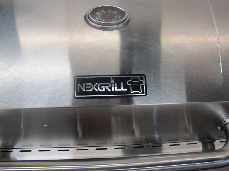 lot 14 image: Nexgrill 4-Burner Propane Gas Grill in Stainless Steel with Side Burner and Stainless Steel Doors - NEW