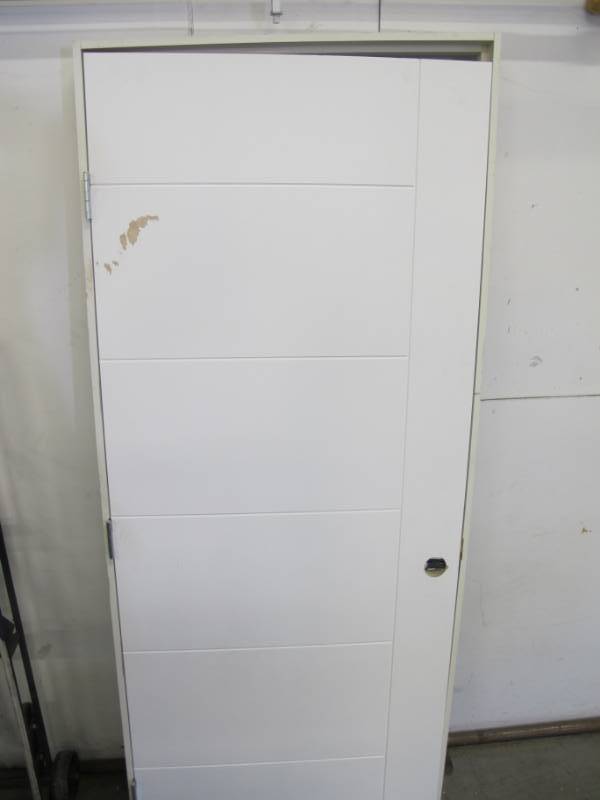 lot 73 image: Steves & Sons 30 in. x 80 in. V-Groove Primed White Barn Door Style Solid Core Wood Single Prehung Interior Door (Damaged)