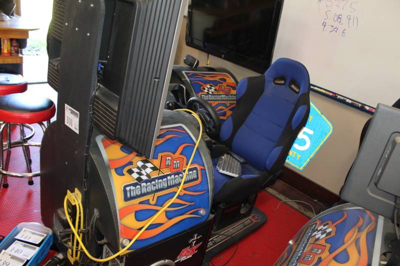 lot 101 image: The Racing Game Seated Video Arcade Game with Racing Seat, Steering Wheel, Display and Stand