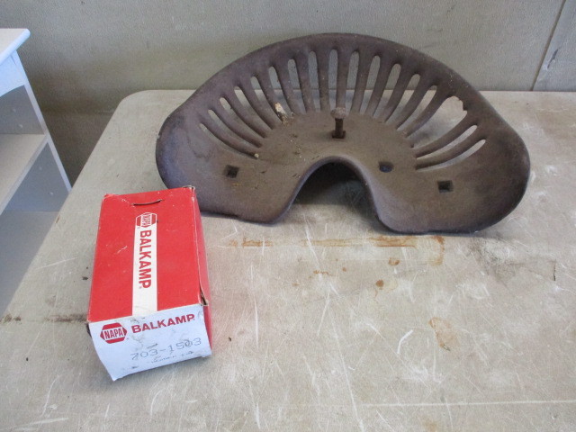 lot 57 image: Antique Tractor seat and weather cap