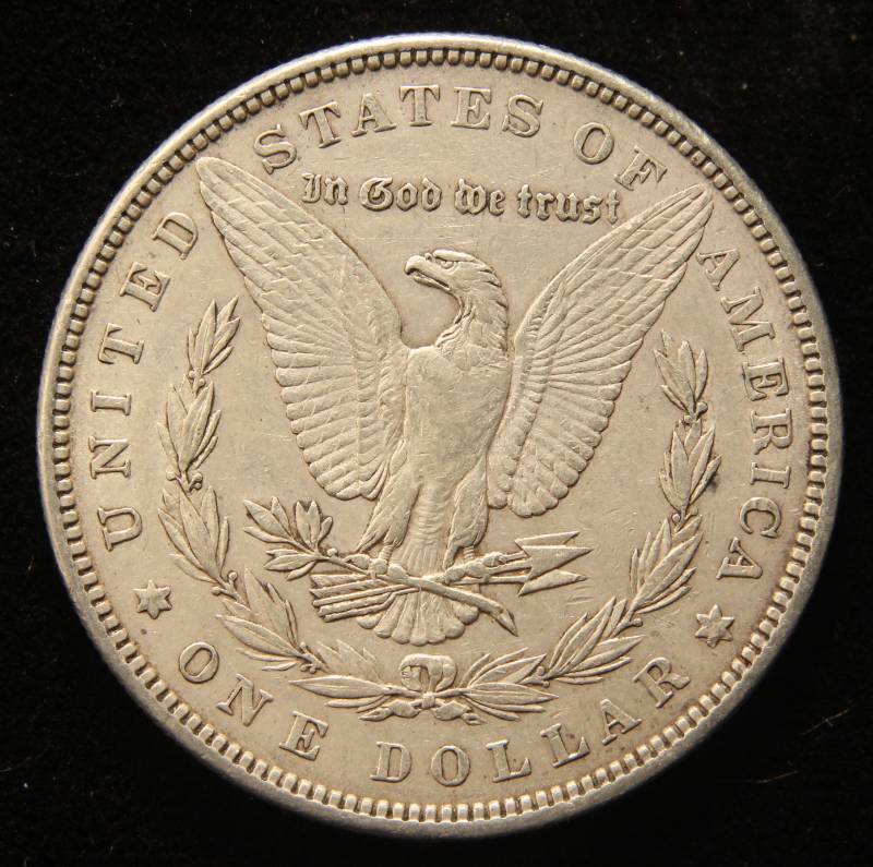 lot 33 image: 1883 MORGAN SILVER DOLLAR CLEANED looks much better in hand