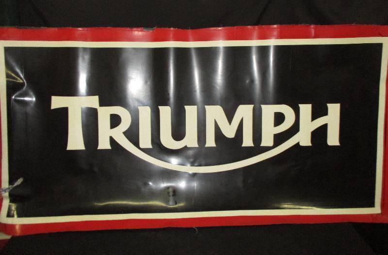 lot 52 image: 34x 71 Rubber Triumph Outdoor Sign