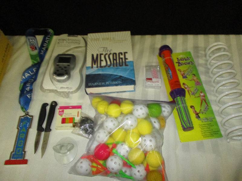 lot 72 image: Gin Rummy Game, Plastic and littlle rubber balls, Spring, Water shooter, Knives, Bible Candles, Metal and more