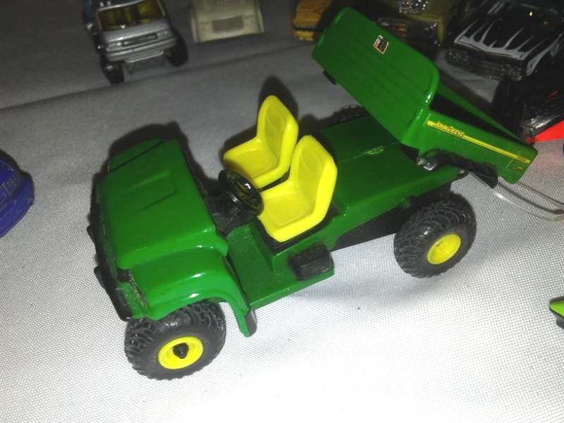 lot 155 image: NERTL John Deere ATV toy and Matchbox and Hot wheels.