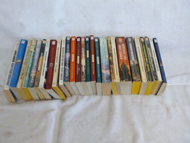 lot 77 image: 27 Louis LAmour Paperback Books