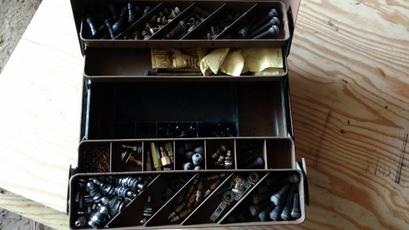 lot 64 image: Vintage metal tool box full of valve stems